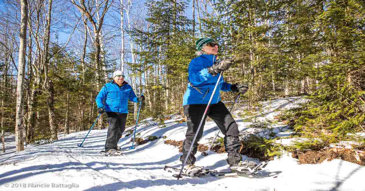 two people cross country snowshoeing