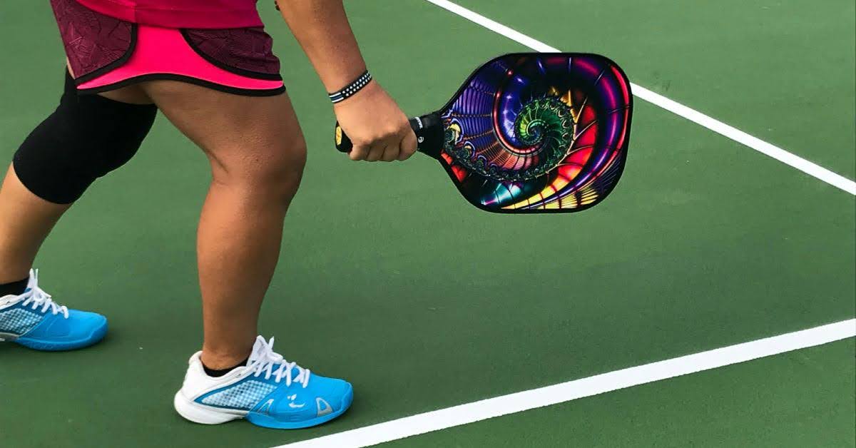 lower half of someone playing pickleball