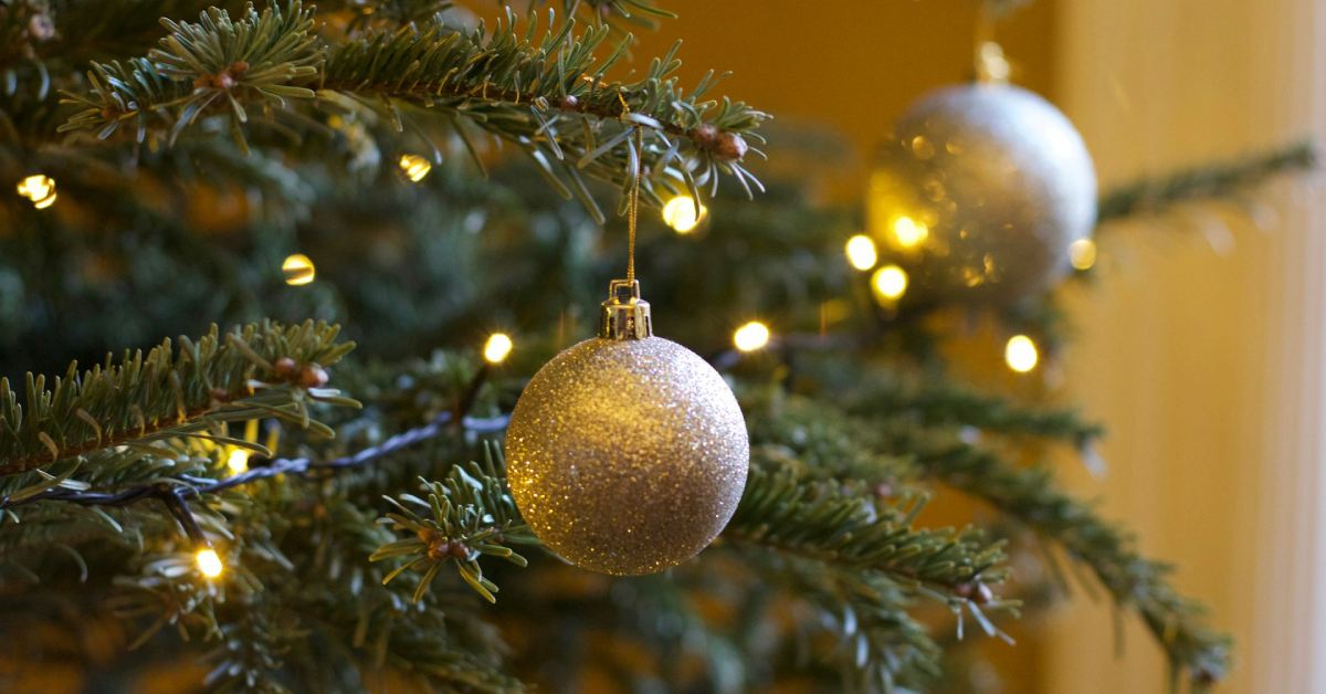 close up of a gold ornament on a tree