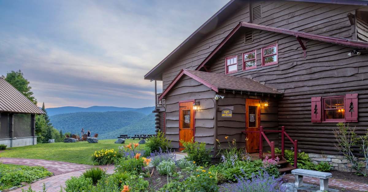 front of a rustic lodge in the evening