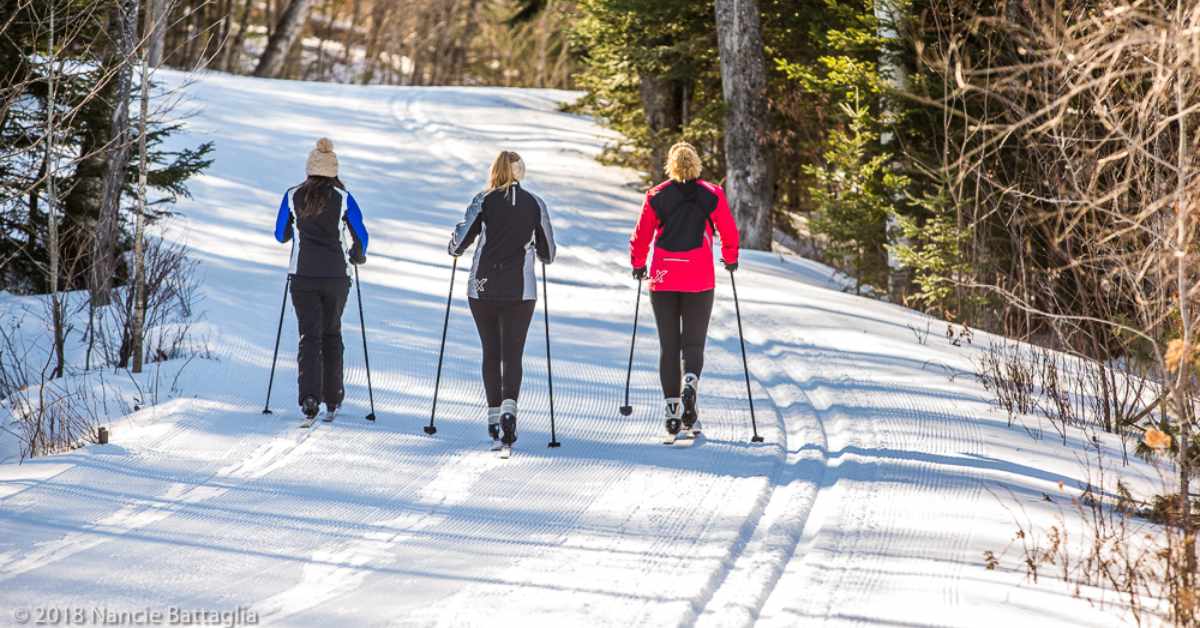three women cross country skiing